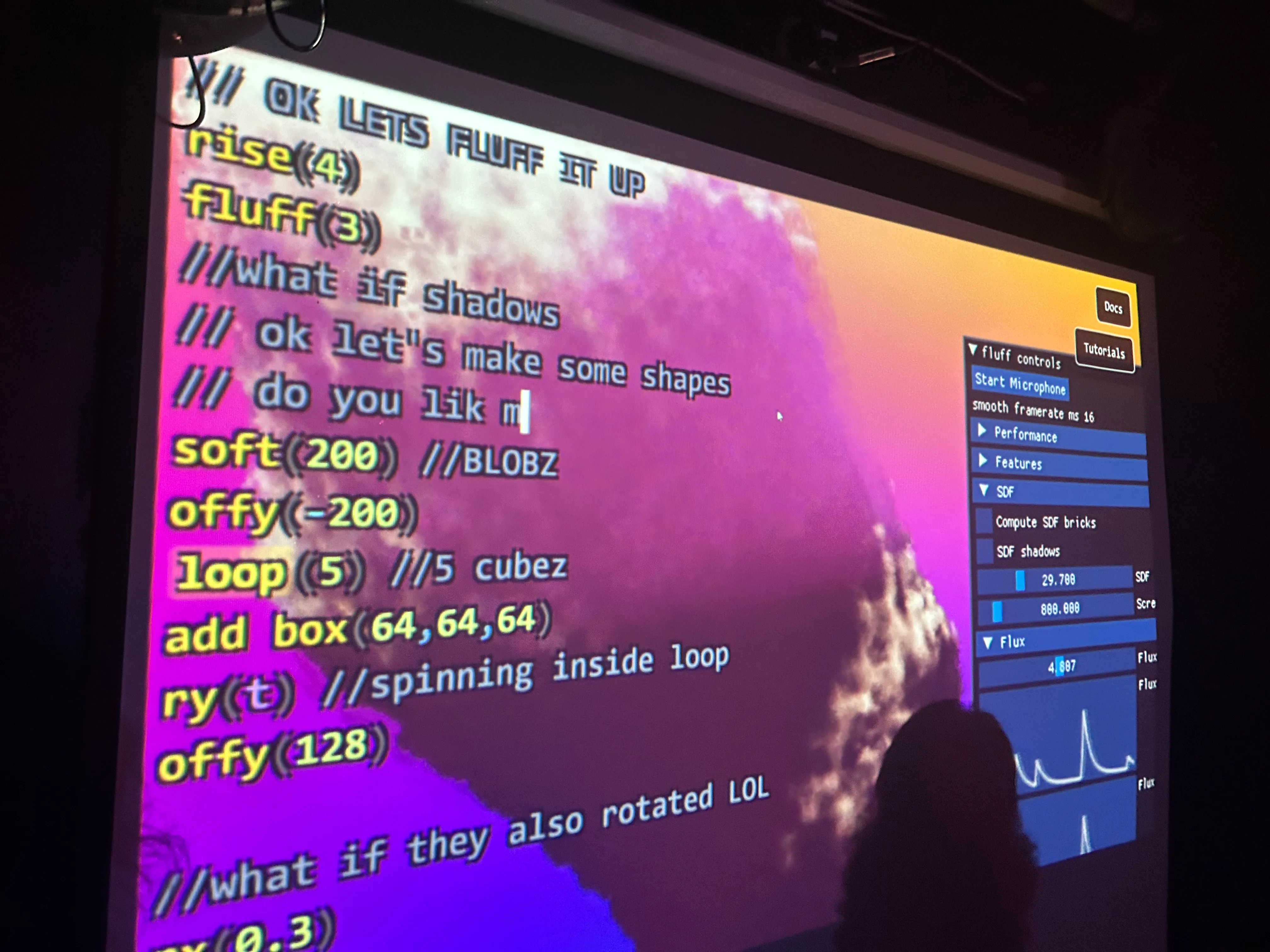 Projection showing Fluff, a tool for live-coding visuals.
